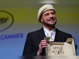 John Travolta On His Viral Beret Look At Cannes: &ldquo;I&rsquo;m Gonna Do An Homage To Being A Director&rdquo;