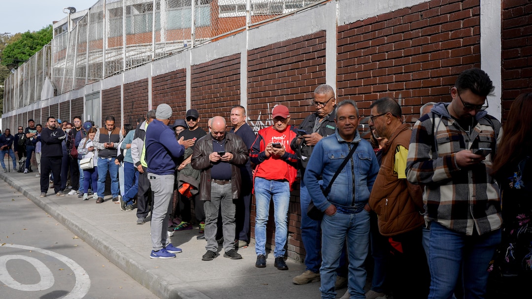 Voters wait in line outside a polling station in Bogota on May 31. 