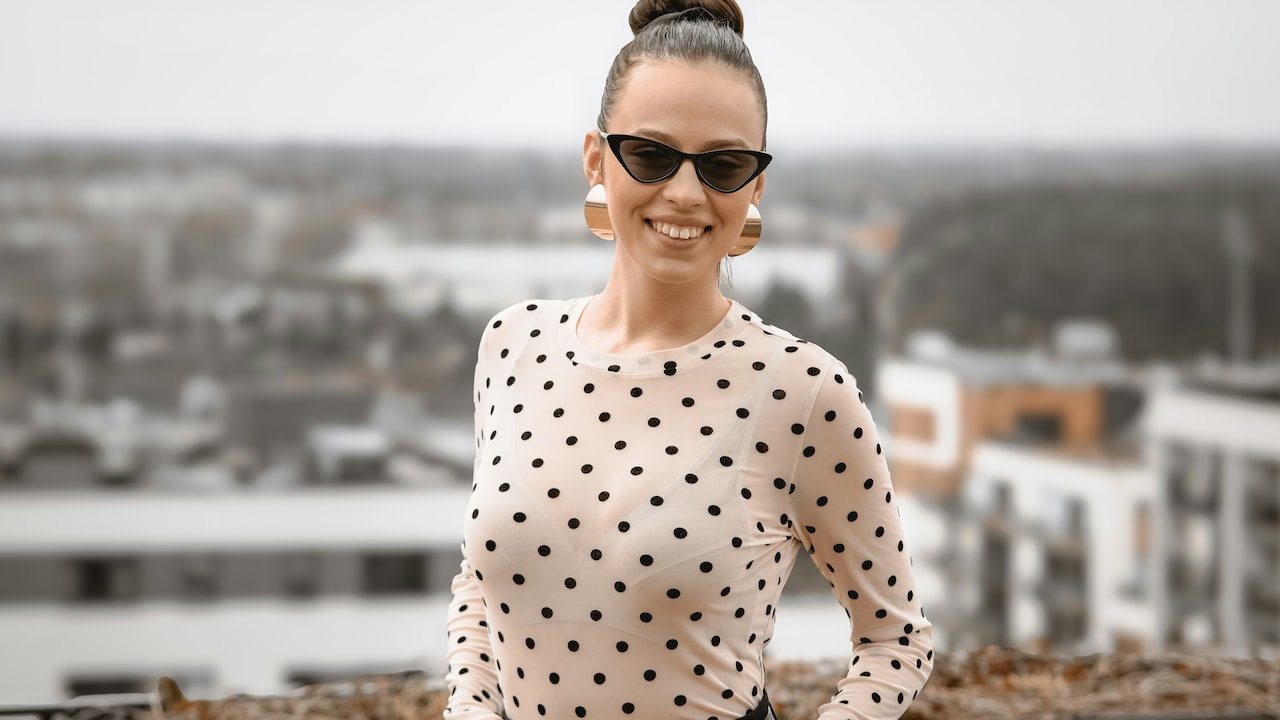 Polka dot tops styled with jeans, skirts, and trousers for every occasion