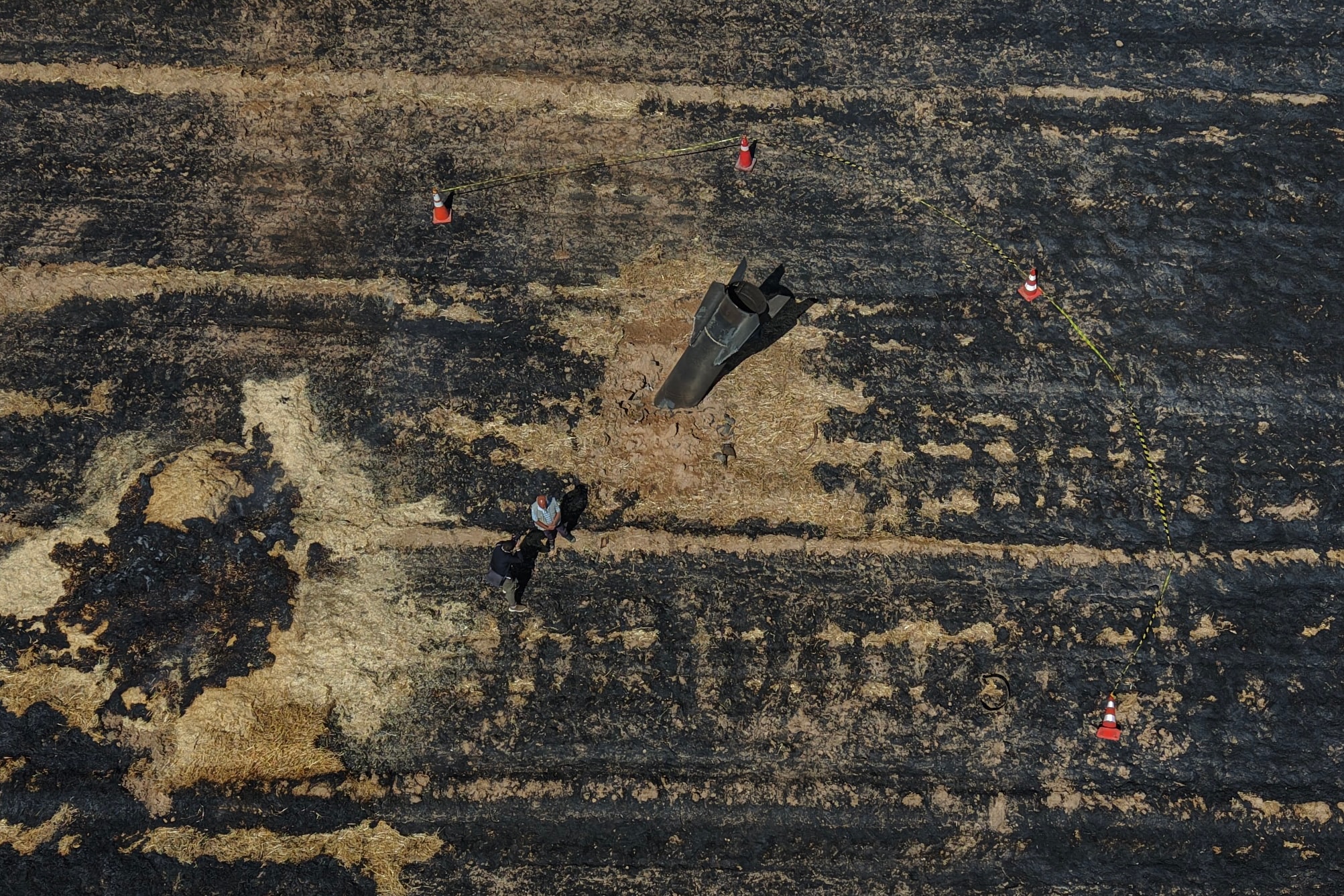 This aerial view shows Syrian farmers standing next to an Iranian missile that fell into an agricultural land in the area of Najha, in the countryside of the Syrian capital after being intercepted by Israeli air defense systems on June 8, 2026. This aerial view shows Syrian farmers standing next to an Iranian missile that fell into an agricultural land in the area of Najha, in the countryside of the Syrian capital after being intercepted by Israeli air defense systems on June 8, 2026.