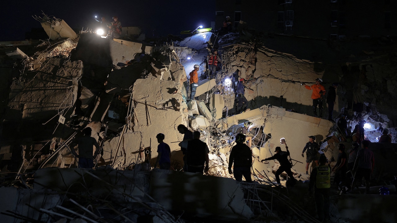 Emergency services work at the site of a collapsed building after an earthquake, in Caracas, Venezuela