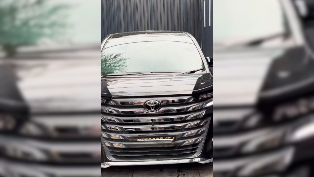 Tom Holland was seated in a black car. 