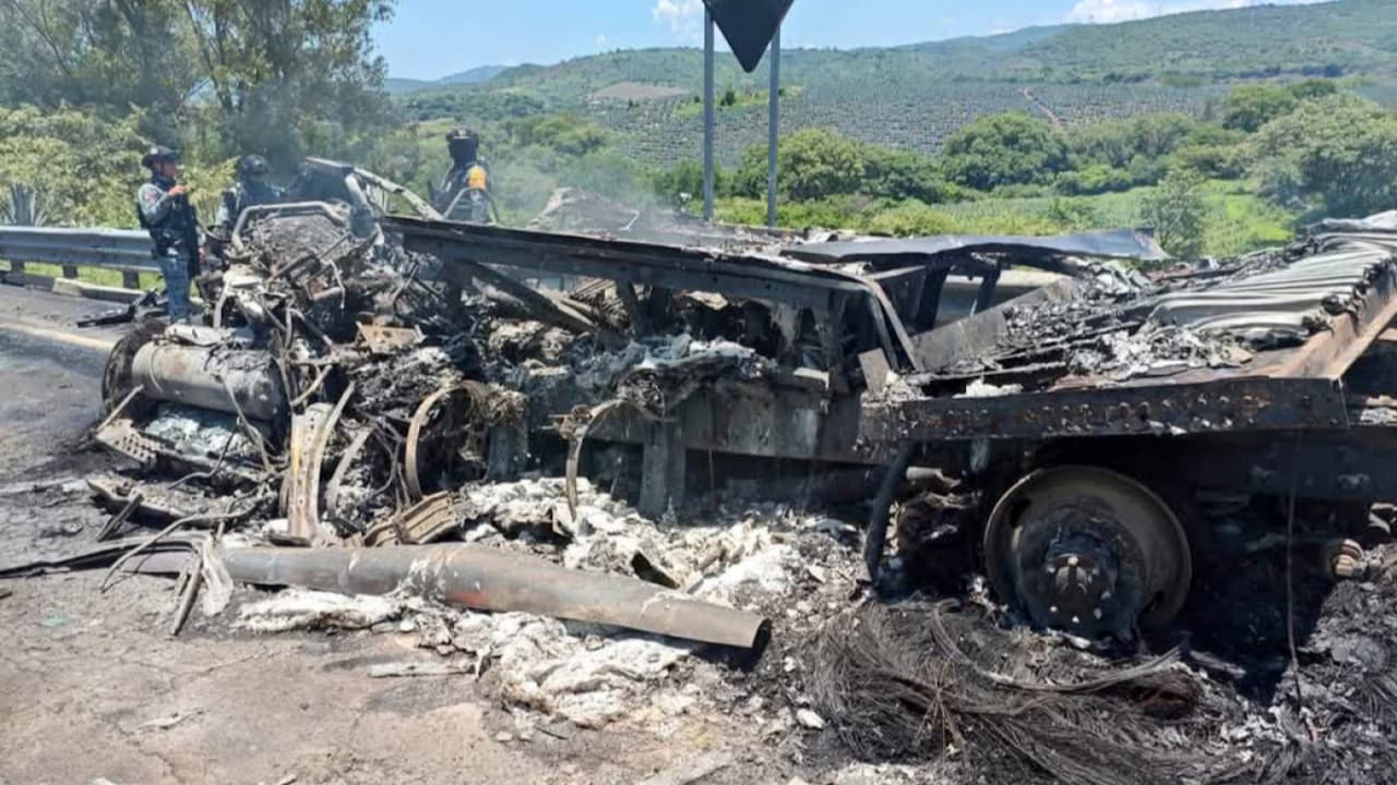 The charred remains of a cargo truck lie scattered across the highway after a fatal multi-vehicle crash near Hostotipaquillo, Jalisco, Mexico