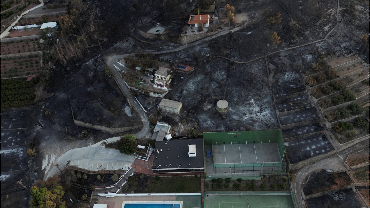 Scorched earth surrounds homes and a pool after Spains wildfire