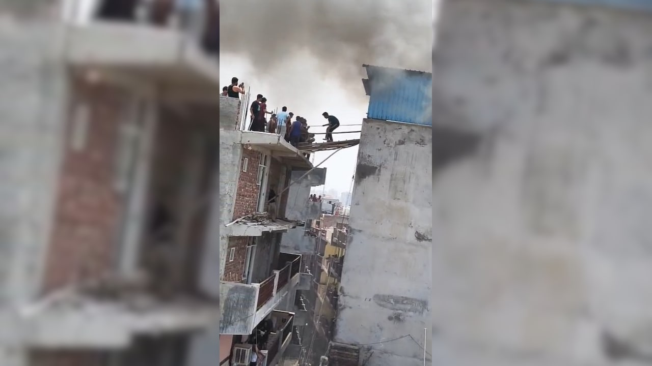 Residents trying to escape the Noida building fire Residents trying to escape the Noida building fire