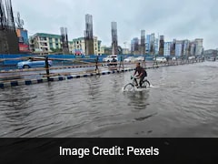 Doctor Pushes Bicycle Through Waist-Deep Floodwater To Reach Hospital