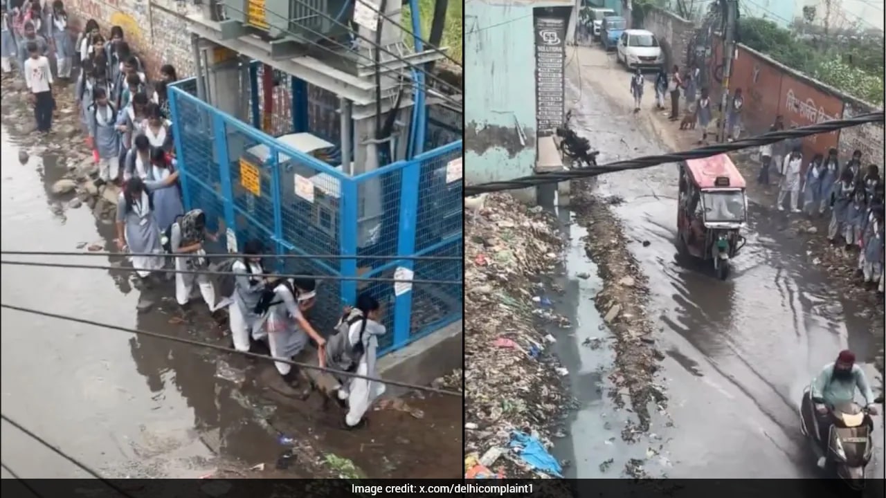 Delhi Rains: Schoolgirls Hold On To Transformer Fence To Cross Waterlogged Road In Swaroop Nagar
