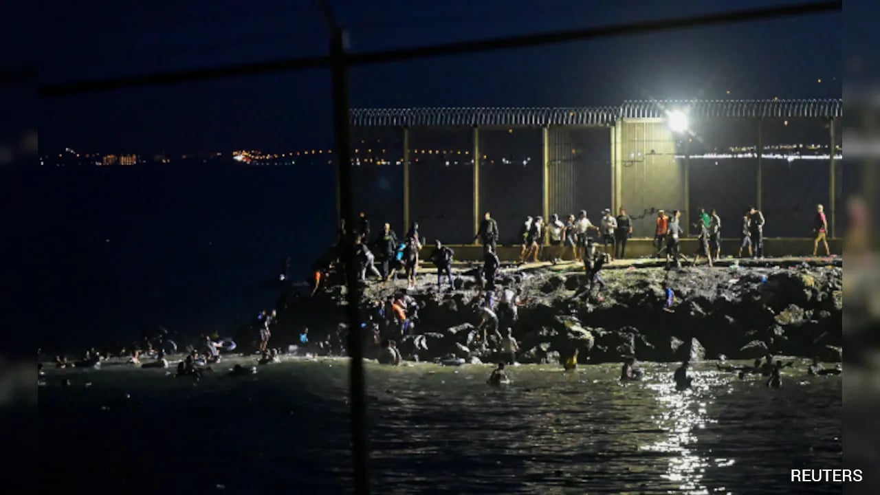 Thousands of migrants enter Spanish enclave of Ceuta from Morocco; at least nine migrants died during the chaotic border crossing.