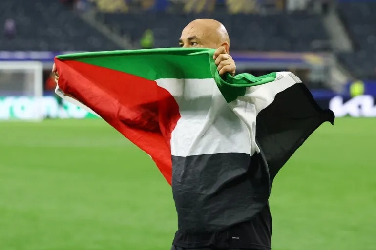 Egypt coach Hossam Hassan raises Palestinian flag after World Cup win over Australia