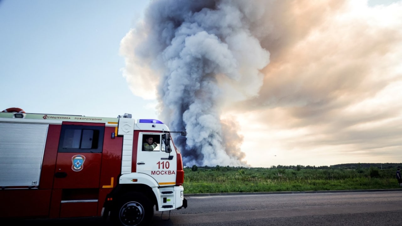 Firefighters drive past the smoke of a fire at the Russian e-commerce firm Wildberries logistics complexes in the town of Elektrostal outside Moscow on July 18, 2026. A Ukrainian drone attack on two logistics centres in Russia killed eight people and injured 24, officials said on July 18, 2026. Firefighters drive past the smoke of a fire at the Russian e-commerce firm Wildberries logistics complexes in the town of Elektrostal outside Moscow on July 18, 2026. A Ukrainian drone attack on two logistics centres in Russia killed eight people and injured 24, officials said on July 18, 2026.