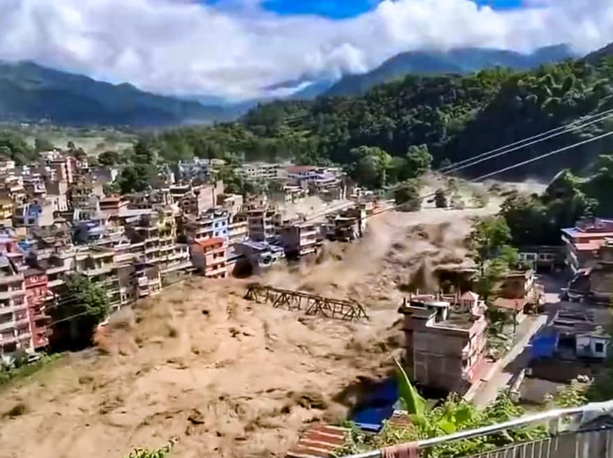 In this screengrab from a video, floodwater flows across a residential area in Nepal