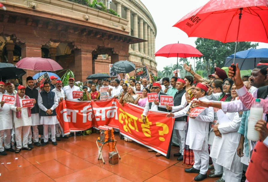 Samajwadi Party chief Akhilesh Yadav with SP MP Dharmendra Yadav and other Opposition MPs hold placards and a banner during a protest at Makar Dwar of Parliament Samajwadi Party chief Akhilesh Yadav with SP MP Dharmendra Yadav and other Opposition MPs hold placards and a banner during a protest at Makar Dwar of Parliament