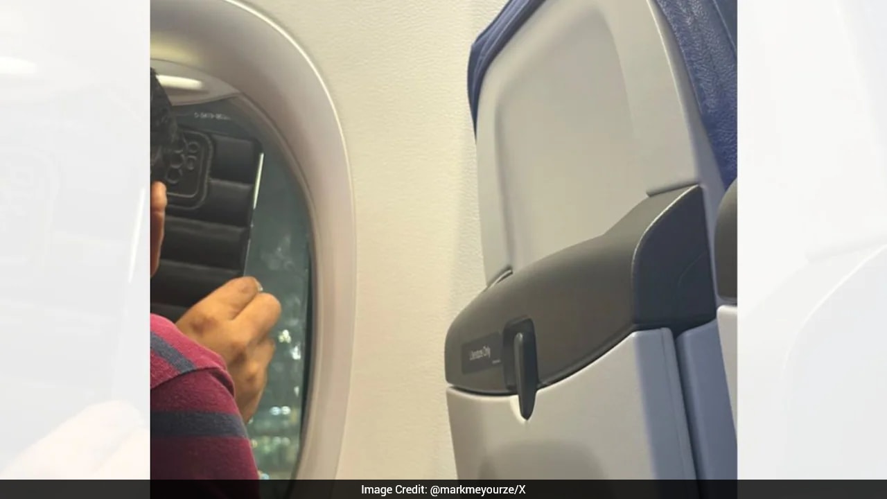 Passenger shares flight window view on video call, moving a woman on board
