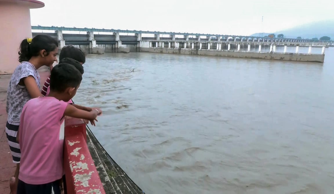 Children at the Gandak Barrage as water levels fluctuated due to the flood situation in Nepal, in West Champaran, Bihar, on Saturday.