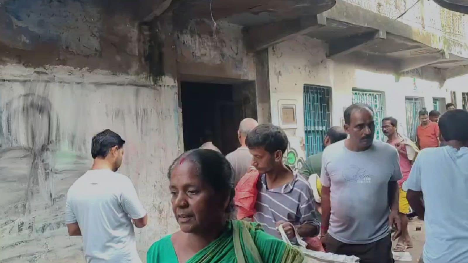 A large crowd gathers outside Asish Banerjees house after hearing about his death
