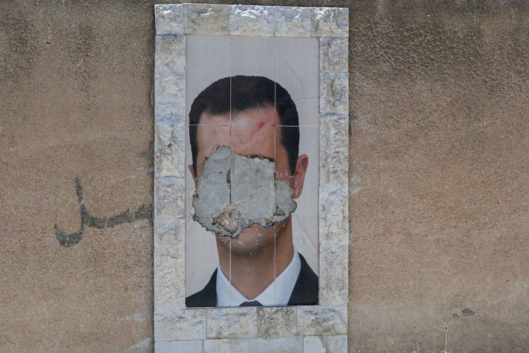 A defaced portrait of Syrias ousted president Bashar al-Assad hangs on a wall in the capital Damascus. A defaced portrait of Syrias ousted president Bashar al-Assad hangs on a wall in the capital Damascus.