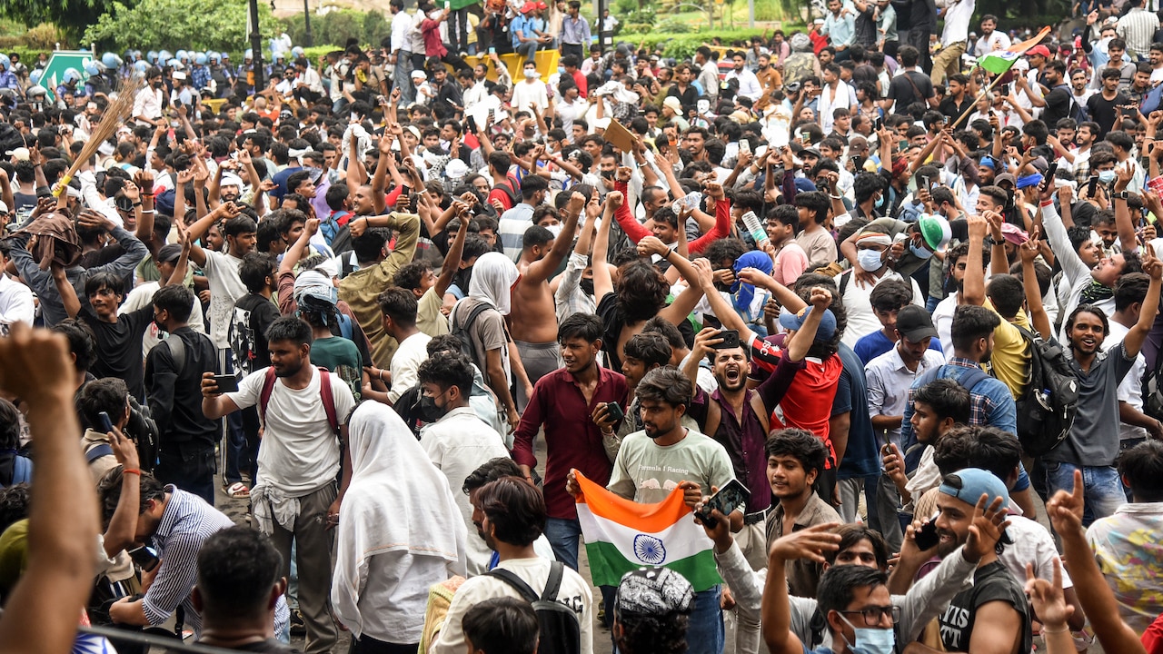 Protesters celebrate at Jantar Mantar after Union Education Minister Dharmendra Pradhan resigns from his post, in New Delhi on July 25