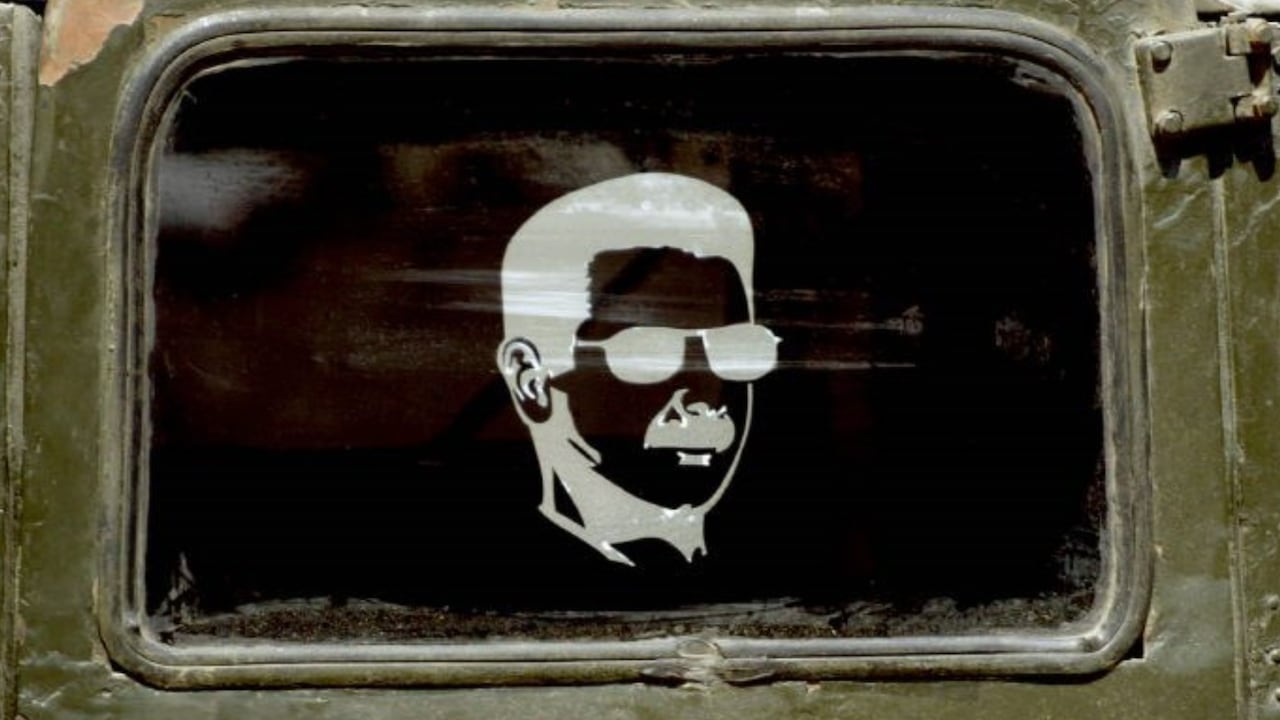 A portrait of the late brother of Bashar al-Assads, Basel, appears on the window of a Syrian army truck