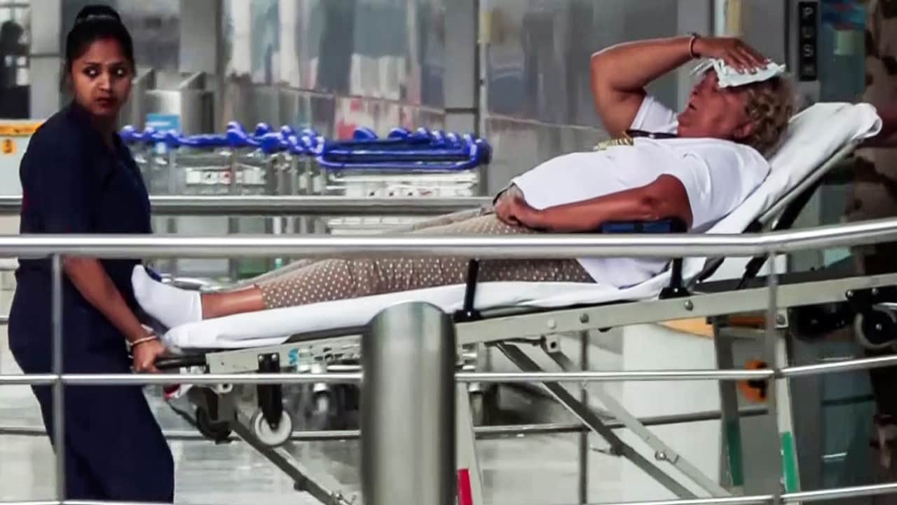 A staff member with an injured passenger on a stretcher A staff member with an injured passenger on a stretcher