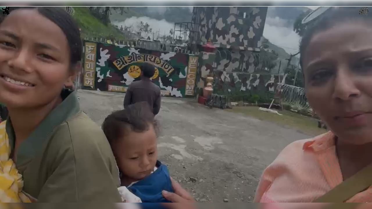 Pema and her son Lamu wait for chopper to take them to Kathmandu