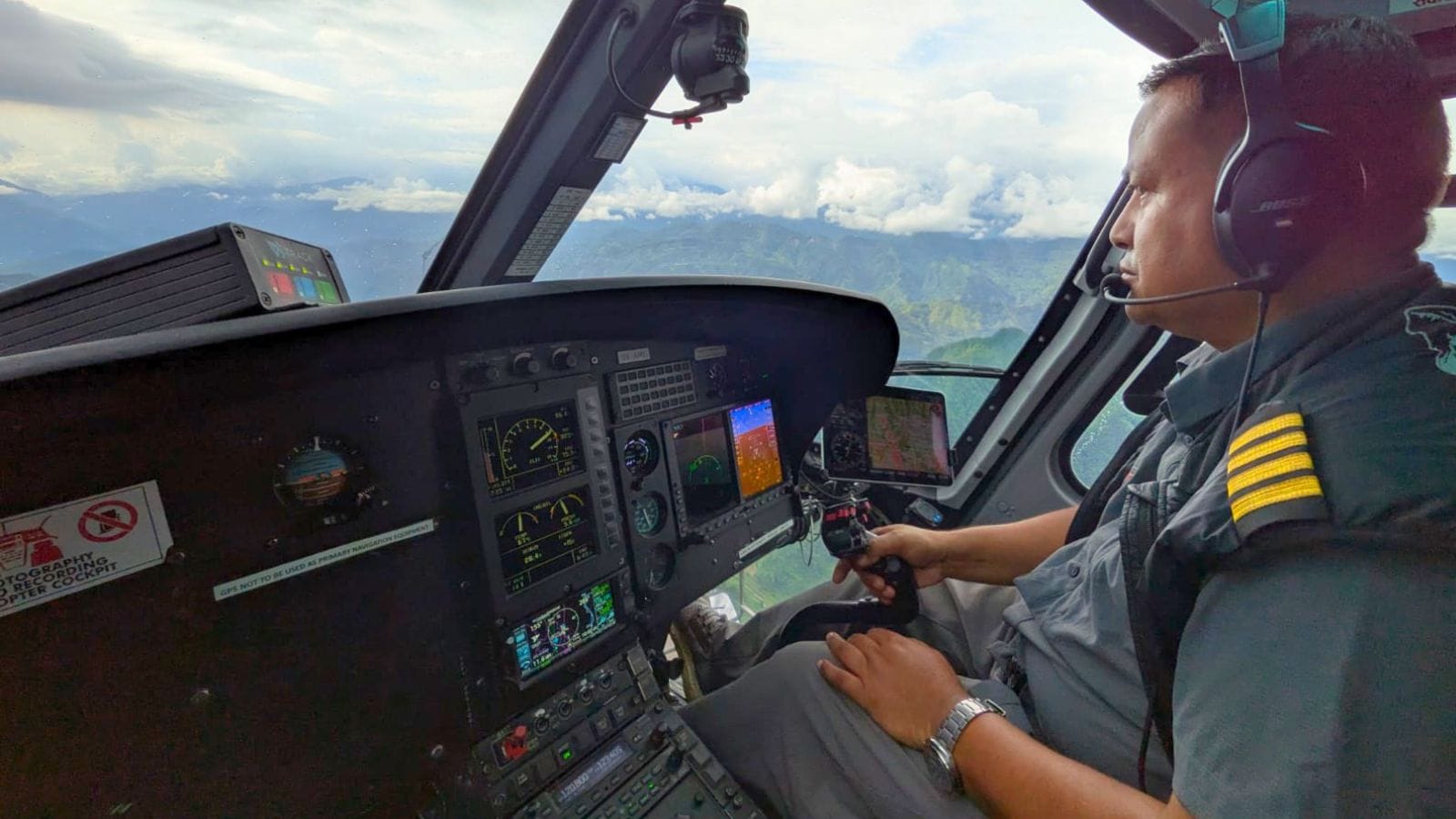 Colonel Rabindra Basnet (retired) at the controls of our helicopter. Colonel Rabindra Basnet (retired) at the controls of our helicopter.