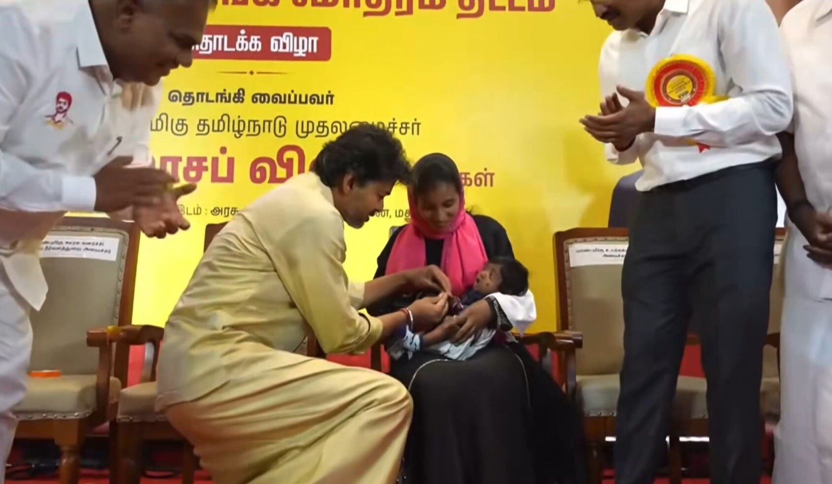 Vijay seen putting a gold ring on a newborn