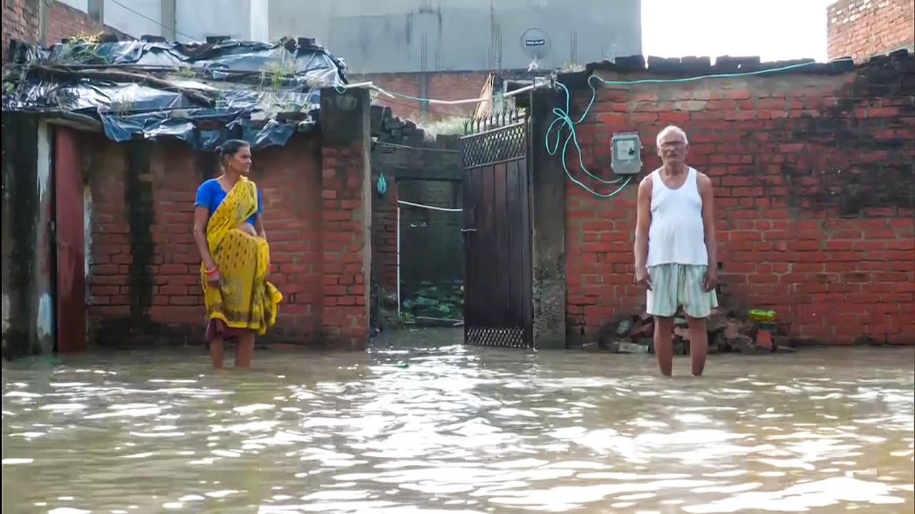 Affected locals stand amid partially submerged houses as heavy rainfall inundates the residential areas along the Pandu River, in Kanpur. Affected locals stand amid partially submerged houses as heavy rainfall inundates the residential areas along the Pandu River, in Kanpur.
