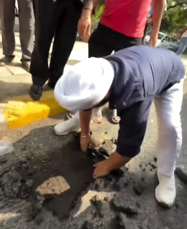Jarnail Singh seen ripping out the freshly paved road Jarnail Singh seen ripping out the freshly paved road