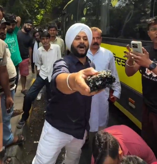 AAP MLA Jarnail Singh shows off the ripped out asphalt to the Delhi Minister AAP MLA Jarnail Singh shows off the ripped out asphalt to the Delhi Minister