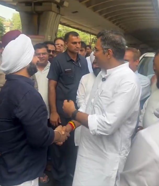 Delhi Minister Parvesh Verma (in white kurta) seen shaking hands with AAP MLA Jarnail Singh Delhi Minister Parvesh Verma (in white kurta) seen shaking hands with AAP MLA Jarnail Singh
