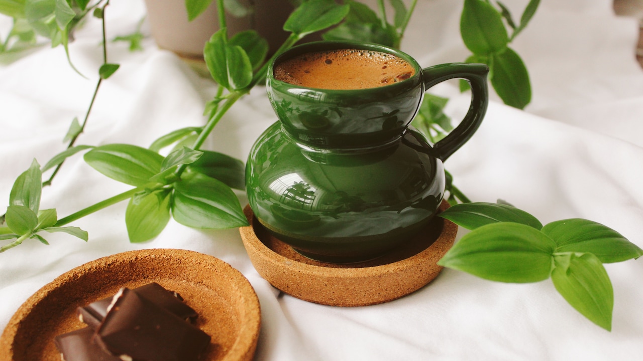 A neat stack of small coasters set beside a warm cup of tea, adding charm to a cosy corner A neat stack of small coasters set beside a warm cup of tea, adding charm to a cosy corner