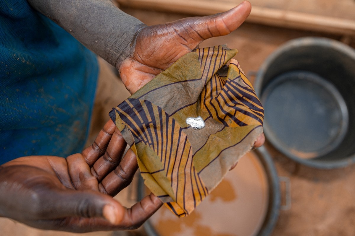 Samuelle Sebi, an artisanal miner, holds a concentrate containing gold particles recovered after the final sorting and concentration stages at an artisanal mine in Mongbwalu, Ituri province. Samuelle Sebi, an artisanal miner, holds a concentrate containing gold particles recovered after the final sorting and concentration stages at an artisanal mine in Mongbwalu, Ituri province.