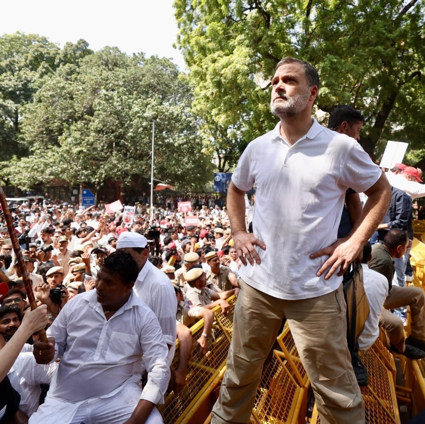 Rahul Gandhi standing atop police barricades