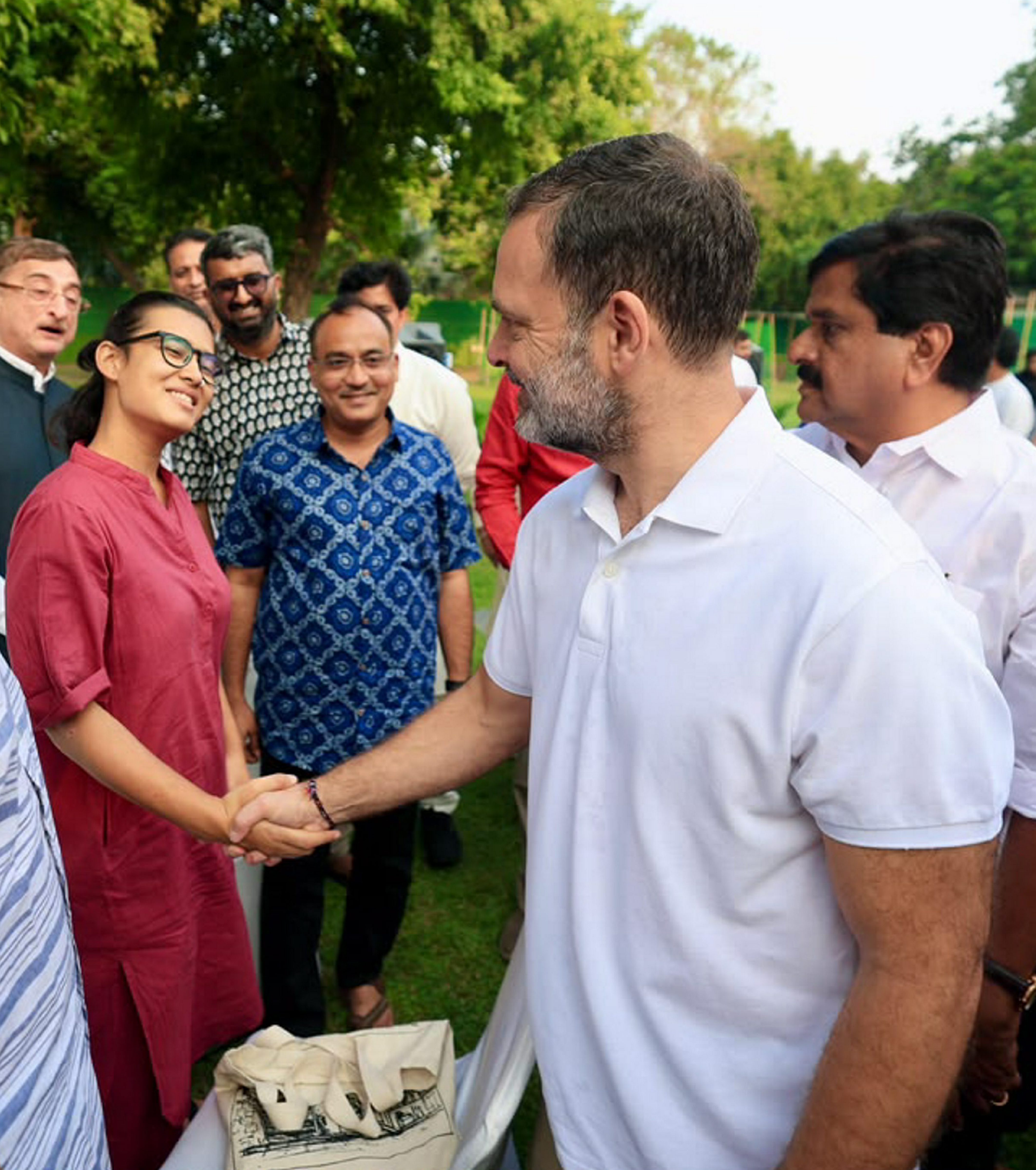 Rahul Gandhi greets Neha Bora during a high tea organised for INDIA bloc leaders at his residence to discuss the strategy for joint protests against "vote chori".