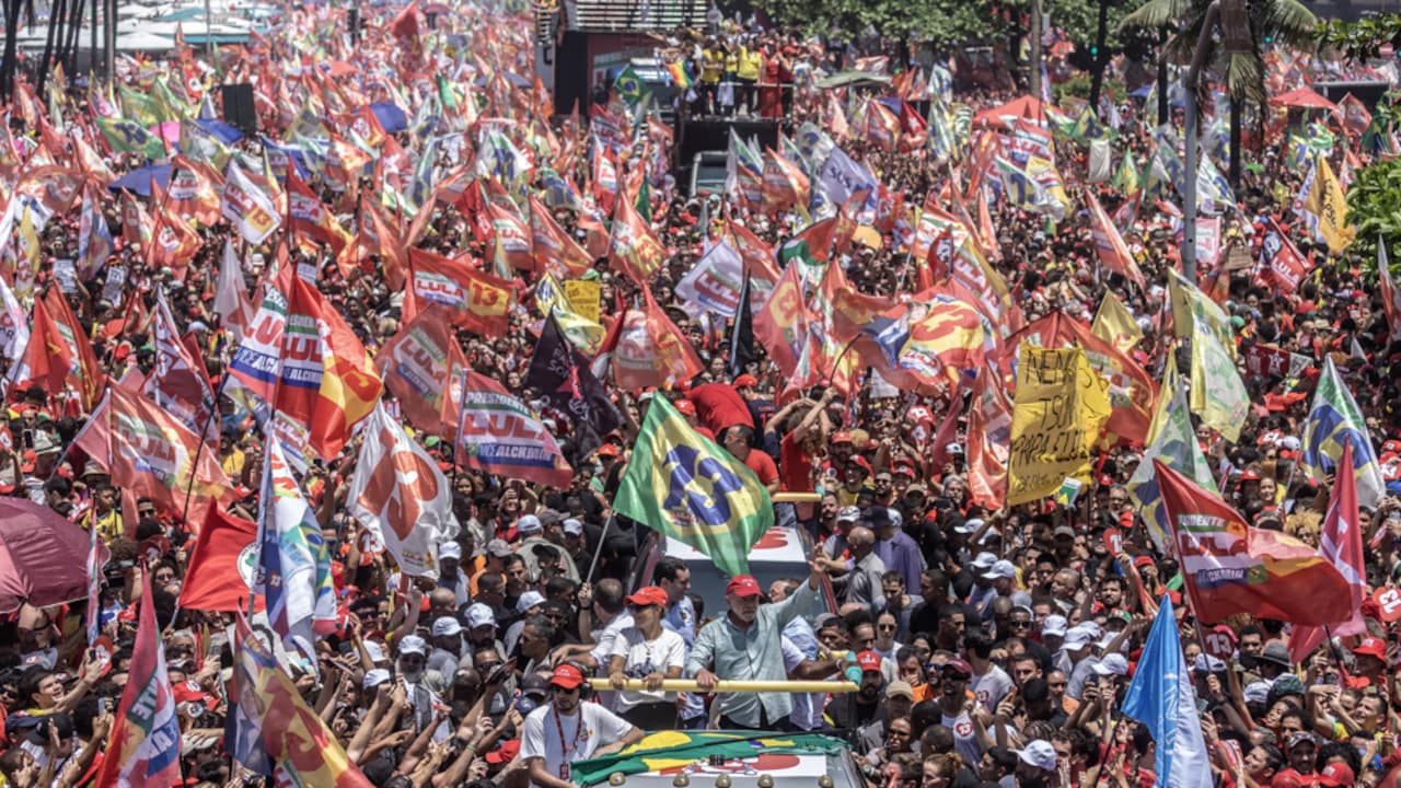 Lula greets supporters at a Copacabana rally.