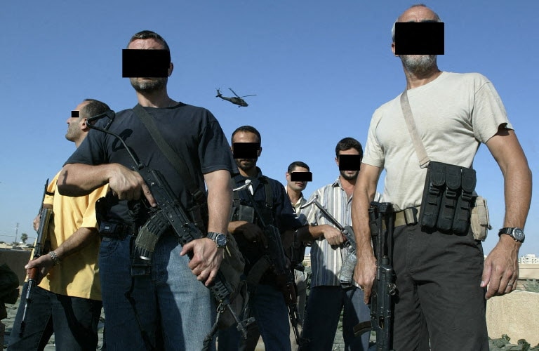 Iraqi and foreign mercenary members of a private security company, stand on the rooftop of a house in Baghdad as a US Blackhawk helicopter flies over, 18 September 2007. Iraq declared today it will review the operations of all security firms working in the war-ravaged country following a deadly shootout involving private US contractor Blackwater. Iraqi and foreign mercenary members of a private security company, stand on the rooftop of a house in Baghdad as a US Blackhawk helicopter flies over, 18 September 2007. Iraq declared today it will review the operations of all security firms working in the war-ravaged country following a deadly shootout involving private US contractor Blackwater.