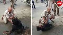 कीचड़ में हाथापाई, वर्दी फाड़ी... बीच सड़क पर पुलिस और युवक के बीच दे दना दन
