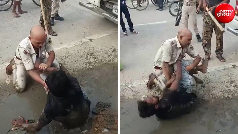 कीचड़ में हाथापाई, वर्दी फाड़ी... बीच सड़क पर पुलिस और युवक के बीच दे दना दन