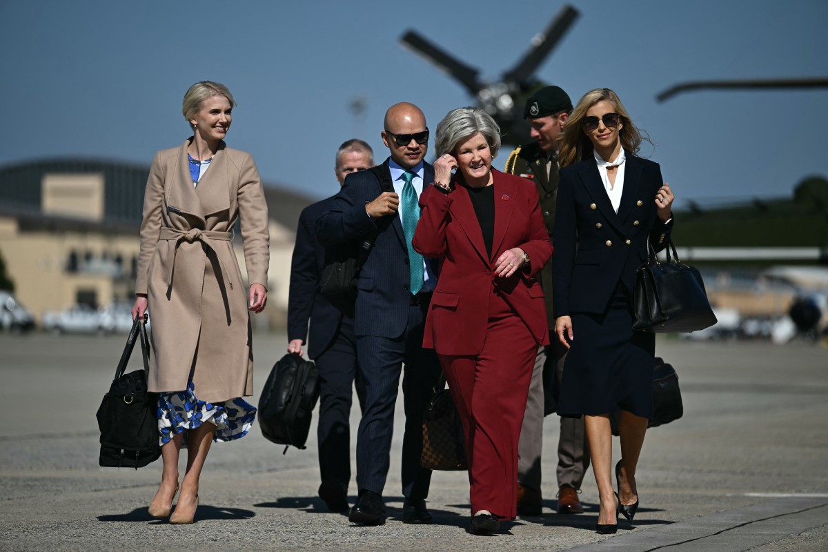 Presidential aide Natalie Harp, White House Chief of Staff Susie Wiles and newly appointed White House Press Secretary Katie Zacharia join US President Donald Trump boarding Air Force One at Joint Base Andrews, Maryland on October 13, 2026.