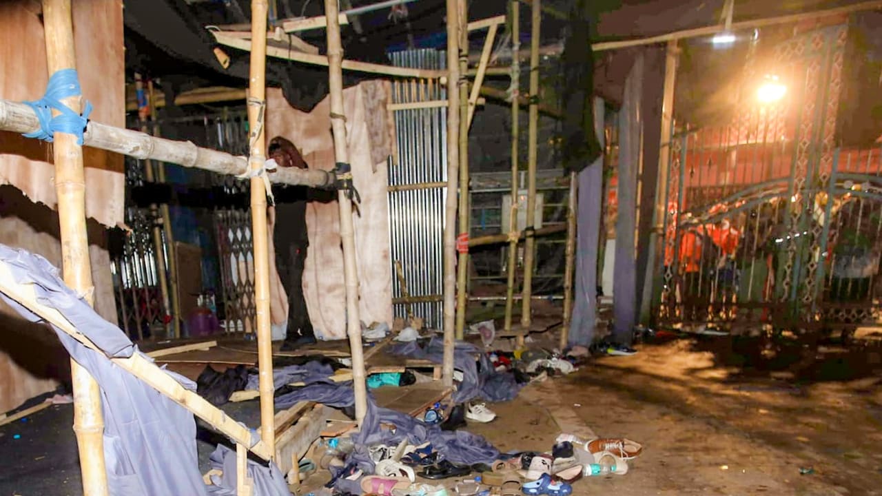 Footwear lies scattered outside a Durga Puja pandal after the exit gate collapsed due to heavy crowd pressure, leading to a stampede