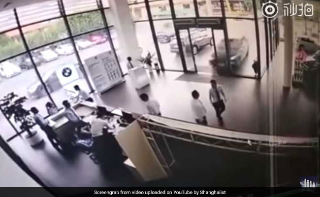 The Moment Woman Crashes BMW She Was Test-Driving Into Showroom
