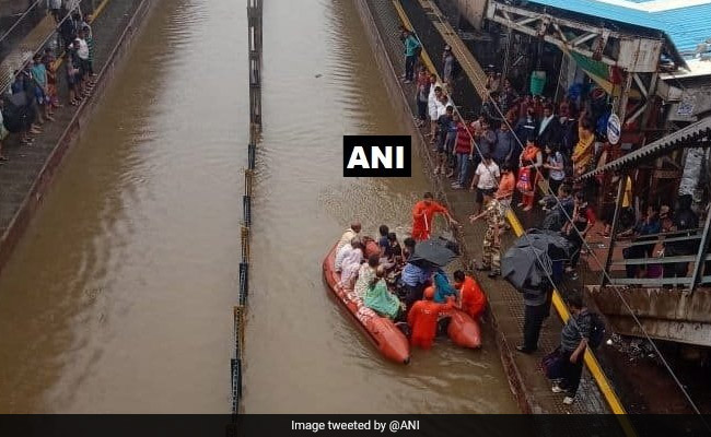 Boats On Flooded Tracks Near Mumbai To Rescue People Stuck In Trains