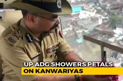 UP Police Officer's Flower Shower For Kanwar Pilgrims Sparks Outrage UP Police Officer's Flower Shower For Kanwar Pilgrims Sparks Outrage