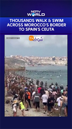 Dramatic Visuals Show Thousands Waling & Swimming Across Morocco's Border to Spain's Ceuta