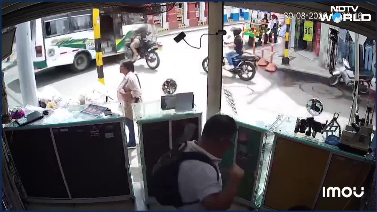 Speeding Biker Flies Through Moving Bus Door In Colombia