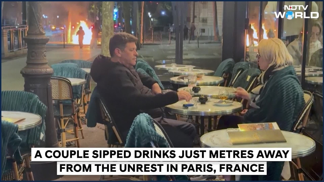 France Protests: Amid Riots And Flames, Couple Enjoys Evening Drink In Paris