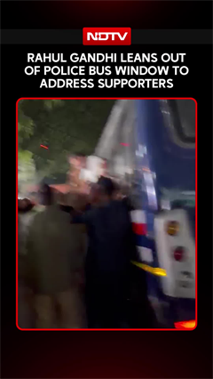 Rahul Gandhi Leans Out Of Police Bus Window To Address Supporters