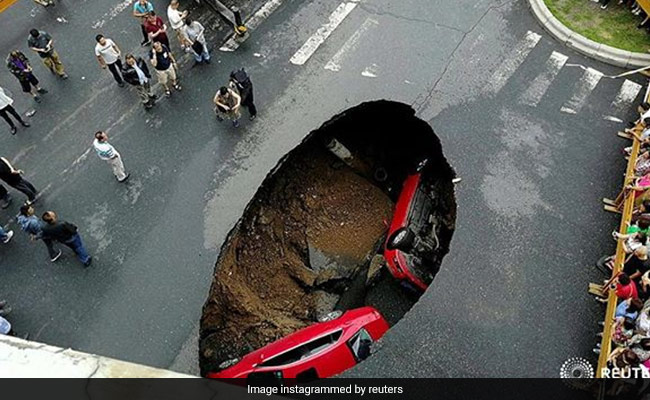 A Sinkhole Opened Up And Swallowed 2 Cars In China. Luckily, Nobody Was Hurt