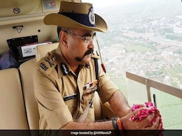 UP Police Officer's Flower Shower For Kanwar Pilgrims Sparks Outrage UP Police Officer's Flower Shower For Kanwar Pilgrims Sparks Outrage