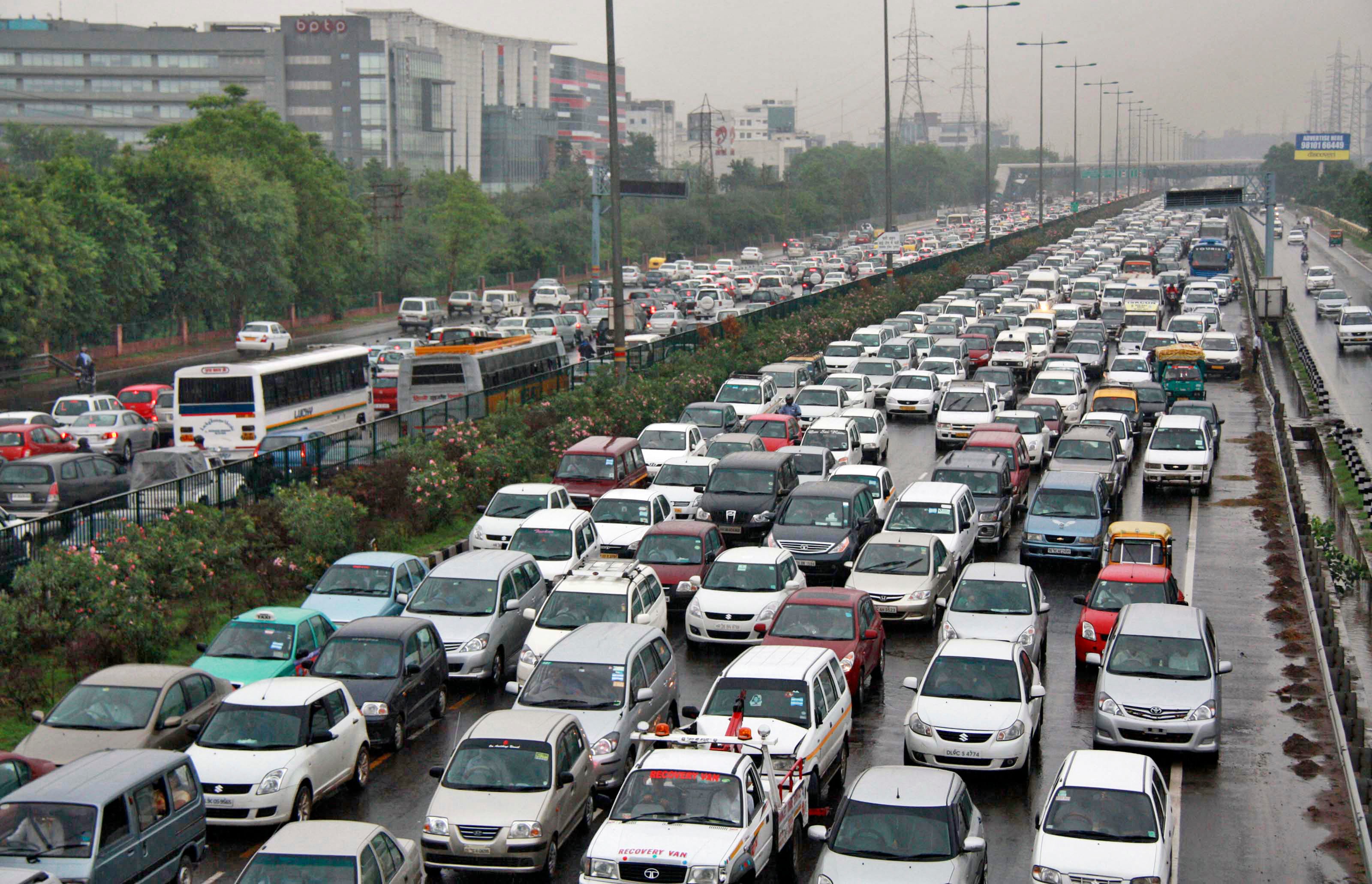 Heavy traffic moves along a busy road as it rains on the outskirts of New Delhi. (Photo: Reuters)